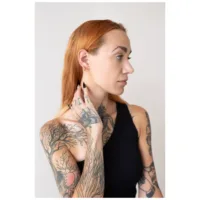 Donna con orecchini Little Bar Hoops dorati, profilo laterale