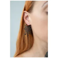 Orecchini Hoops Mandala Neri in Acciaio Chirurgico Orecchini Hoops Mandala Neri su un orecchio con capelli castano chiaro, sfondo grigio