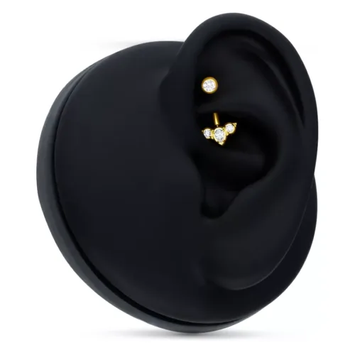 Microbananabell dorato con cristalli chiari su display nero per orecchio