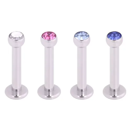 Quattro labret in argento con cristalli chiari, rosa e blu su sfondo bianco