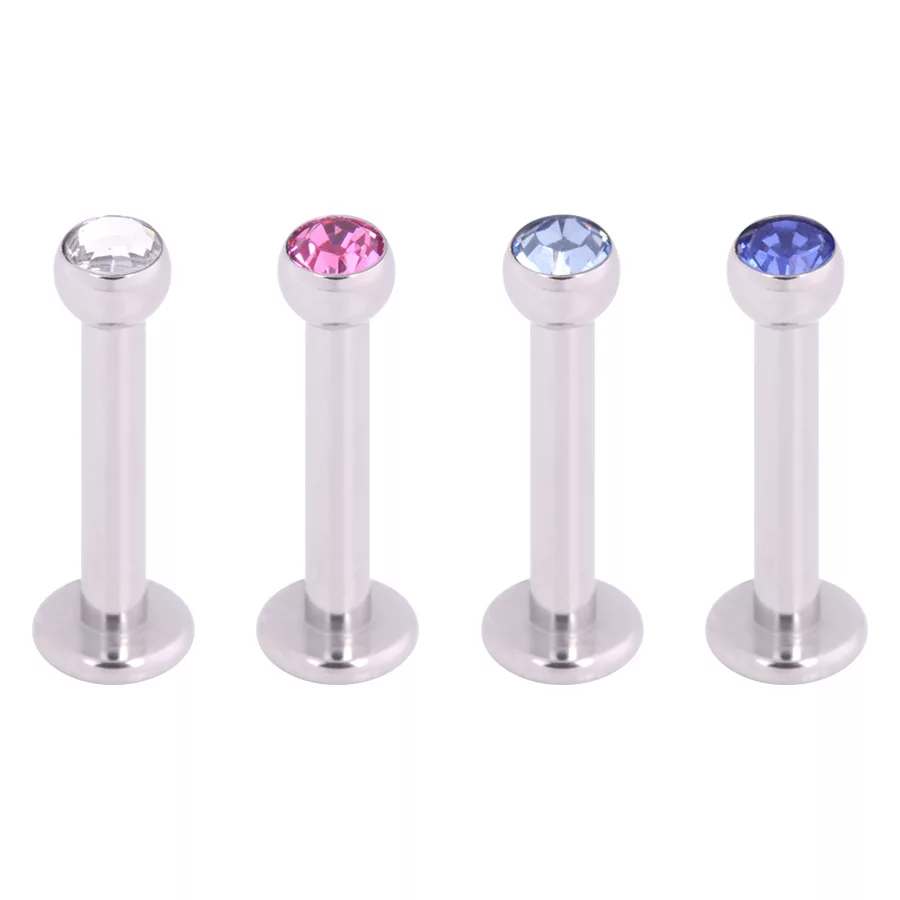 Quattro labret in argento con cristalli chiari, rosa e blu su sfondo bianco
