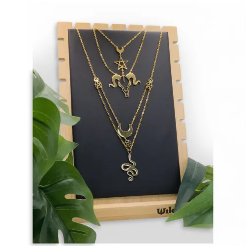 Espositore nero per collane di Wildcat con catene dorate, su cornice in legno.