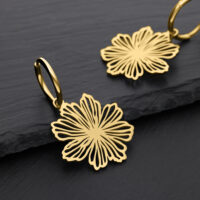 Orecchini Fine Flower dorati in acciaio chirurgico Due orecchini dorati a forma di fiore su sfondo nero