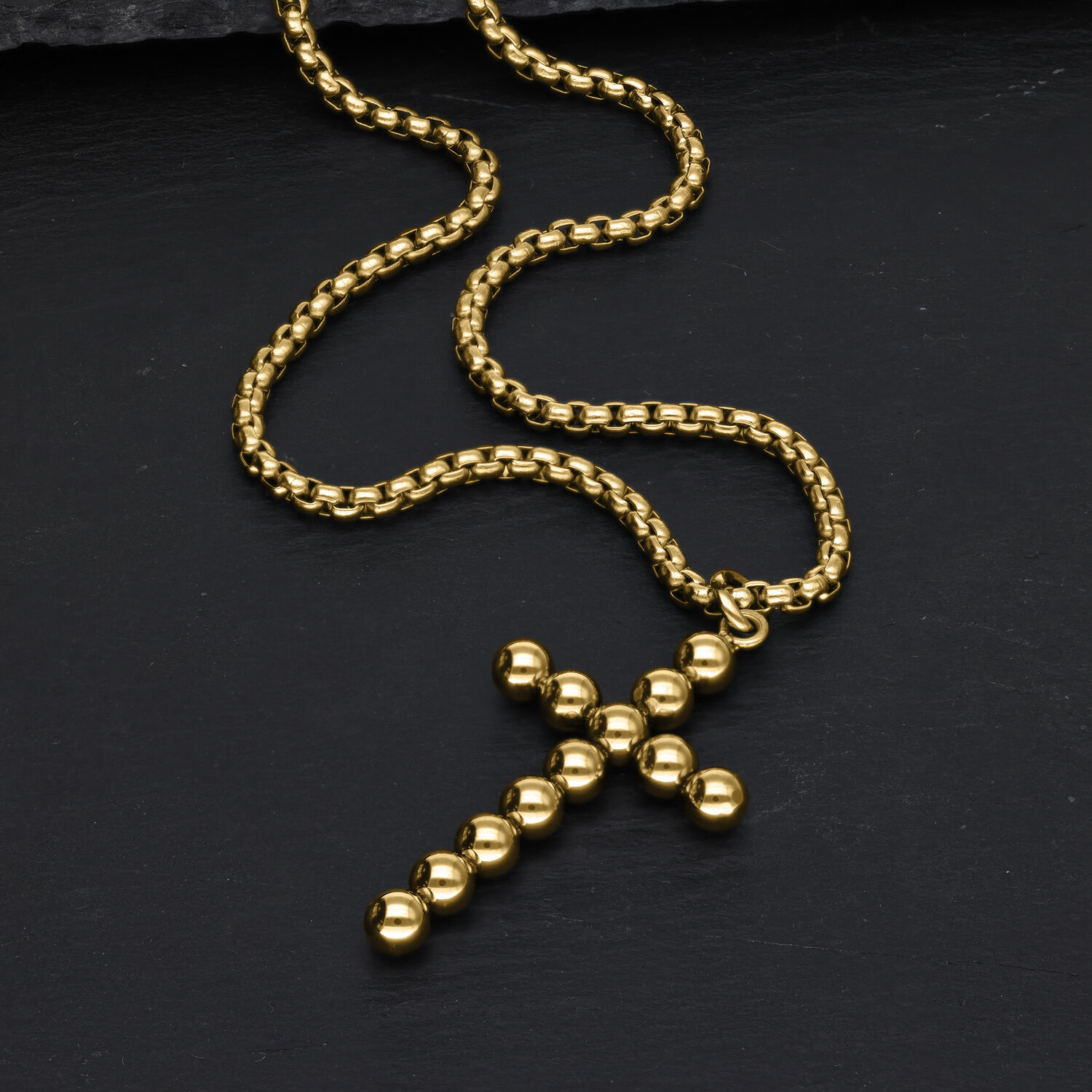 Collana Croce Bubble Dorata in Acciaio Chirurgico Collana croce dorata con sfere su sfondo nero
