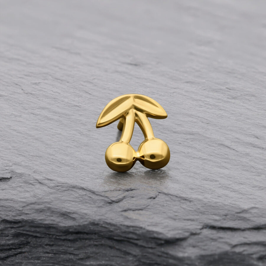 Accessorio a ciliegia in oro 14K su sfondo grigio