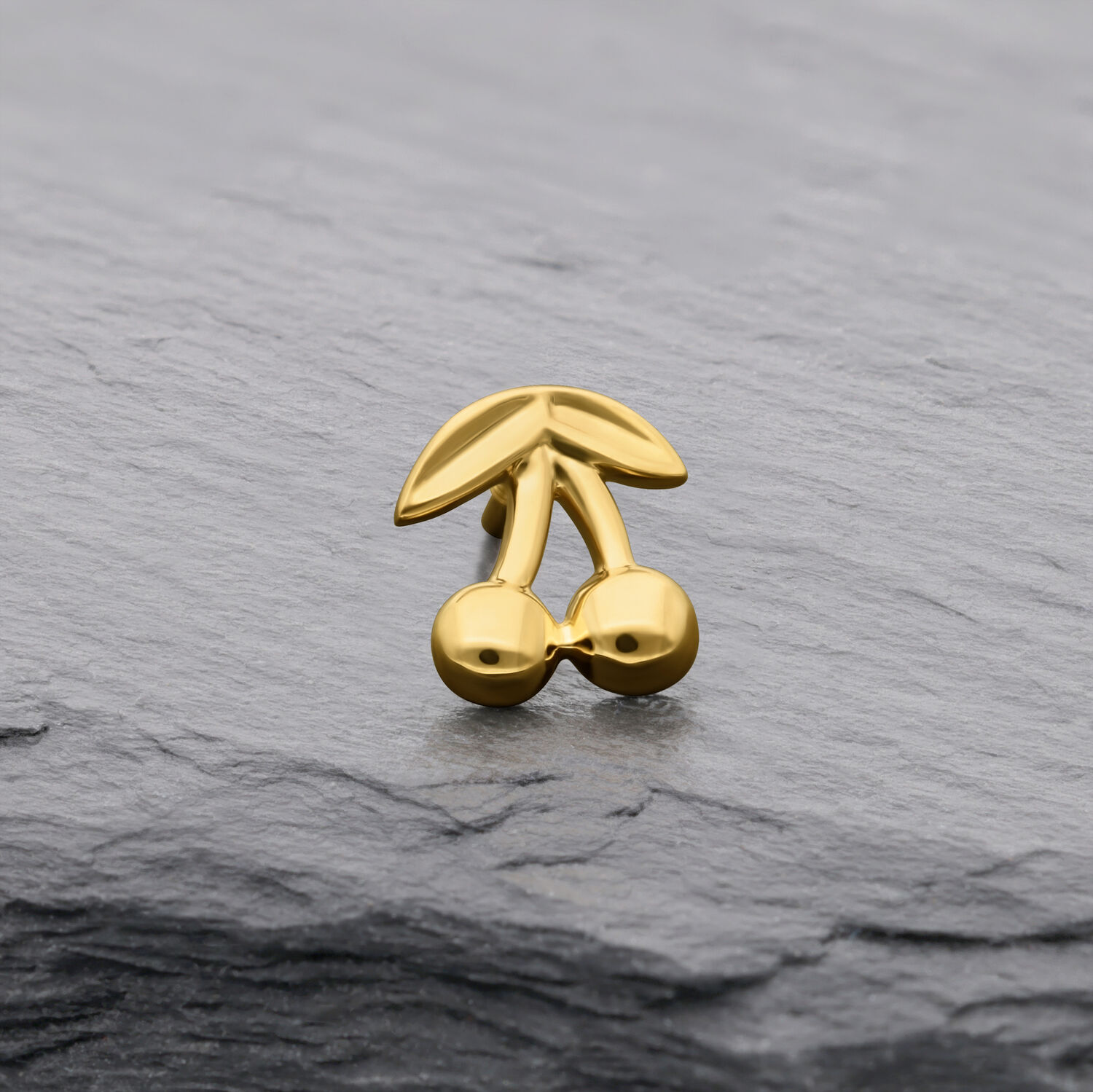 Accessorio a ciliegia in oro 14K su sfondo grigio