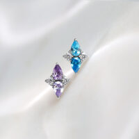 Due inserti Push Fit in titanio color lavanda e turchese su sfondo bianco