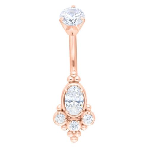 Piercing all'ombelico in oro rosa con cristalli chiari su sfondo bianco
