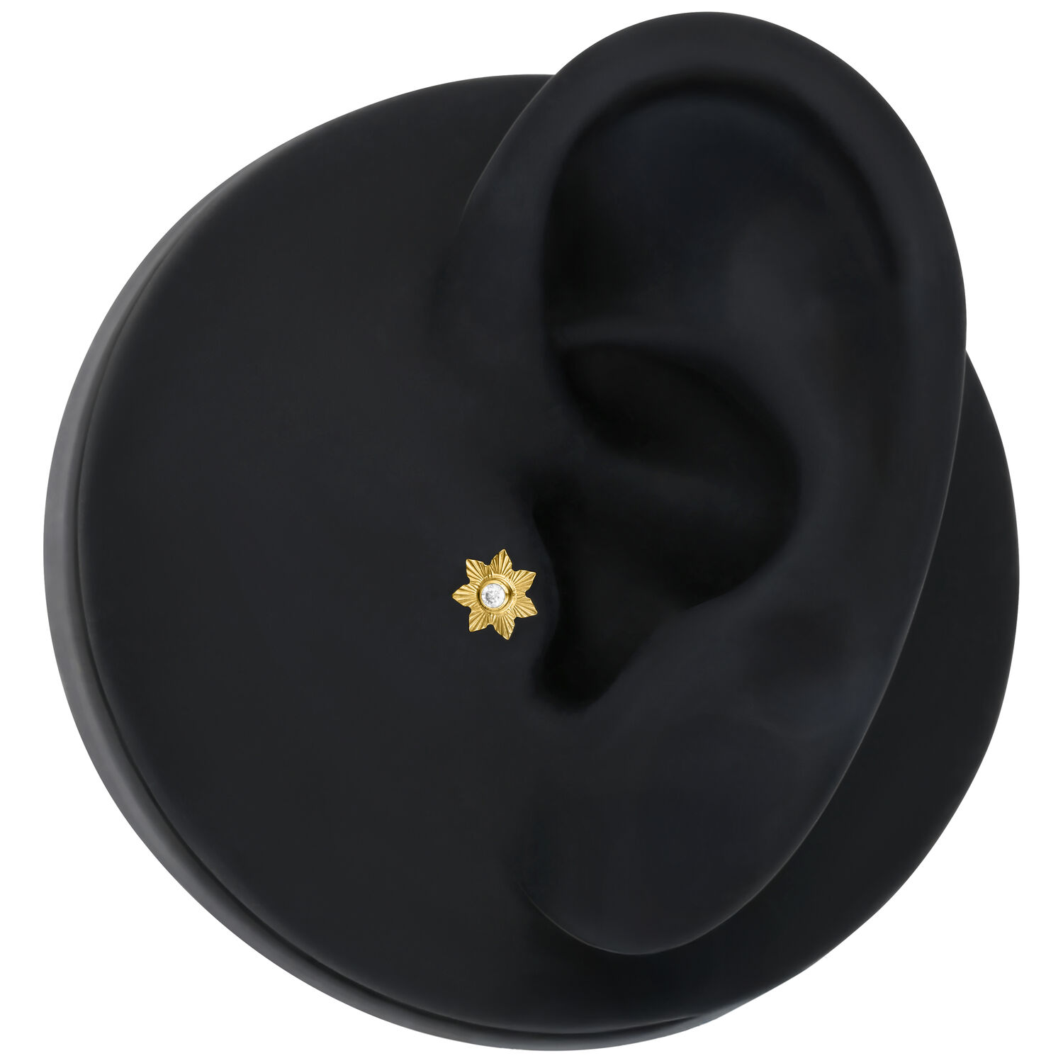Inserto per piercing dorato Push Fit Inserto per piercing dorato Push Fit con cristallo su sfondo nero