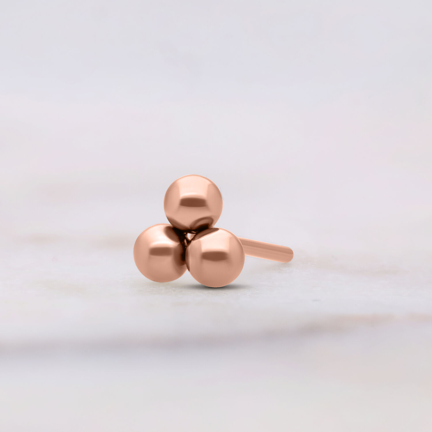 Attacco Push Fit Trinity in oro rosa su sfondo chiaro