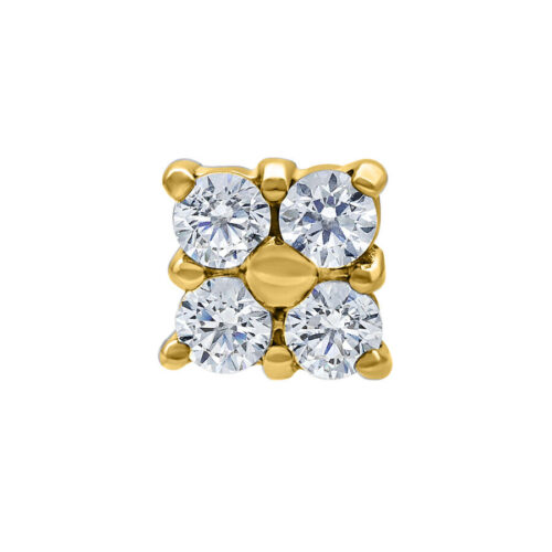 Punta per piercing dorata con quattro cristalli chiari su sfondo bianco