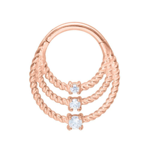 Anelli piercing intrecciati in oro rosa con tre cristalli su sfondo bianco