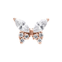 Accessorio piercing a farfalla in oro rosa con cristalli chiari su sfondo bianco