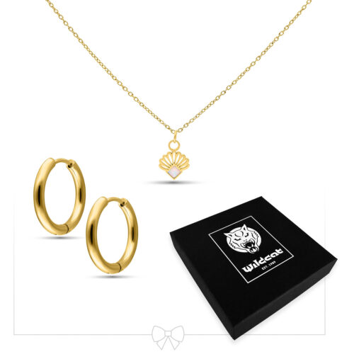Collana dorata con ciondolo a conchiglia e cerchi dorati davanti a una scatola regalo nera