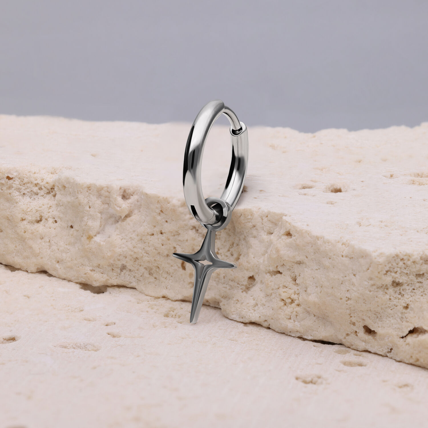 Orecchino in argento con ciondolo a forma di stella polare su pietra chiara